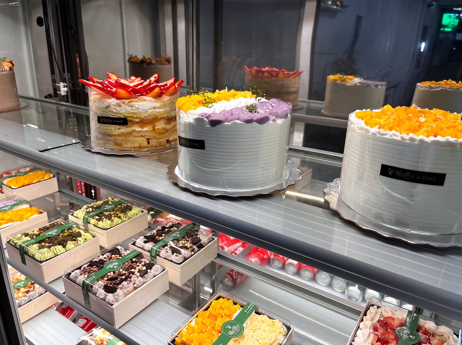 X-Cake display case with mango, taro and strawberry crepe cakes